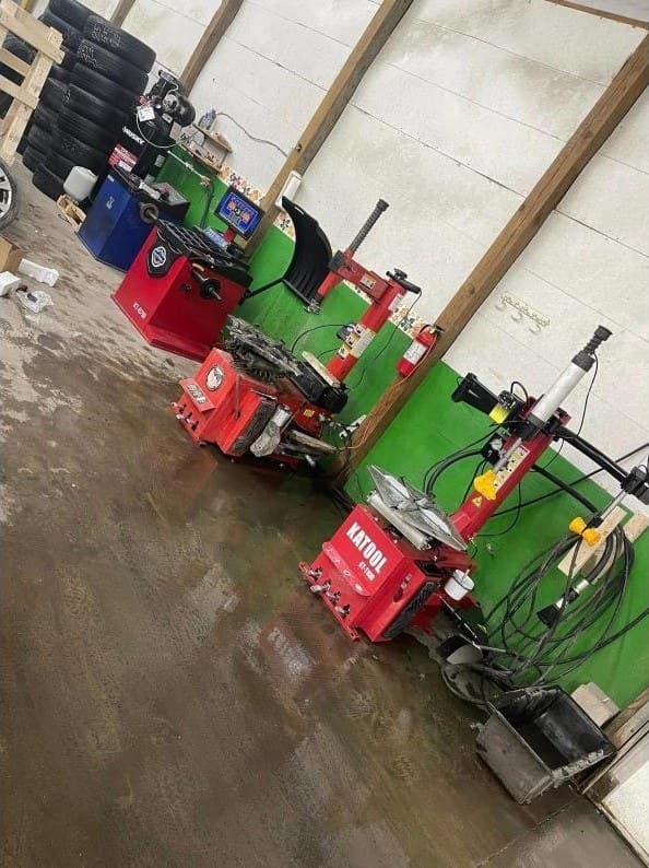 Row of red tire changing and balancing machines